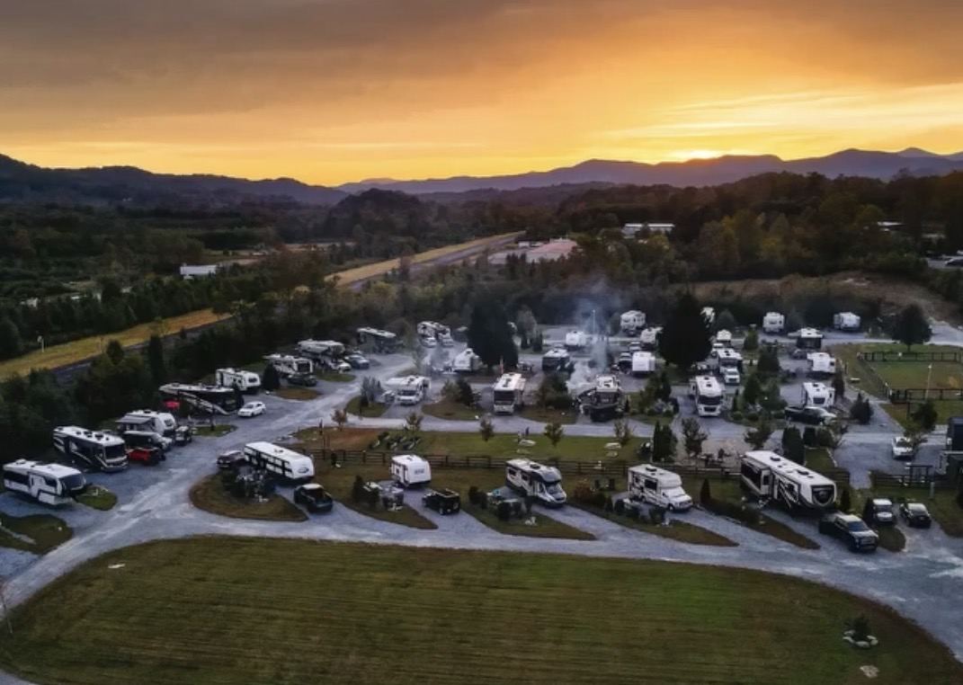 Aerial view of a mountain RV park at sunset