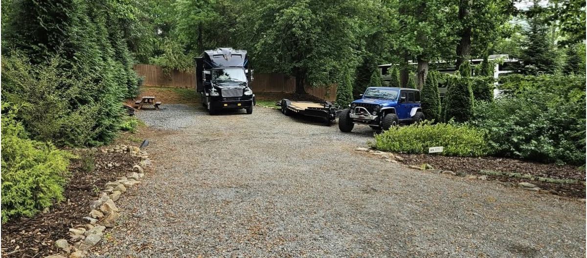 Private wooded RV site with gravel pad and stone edging